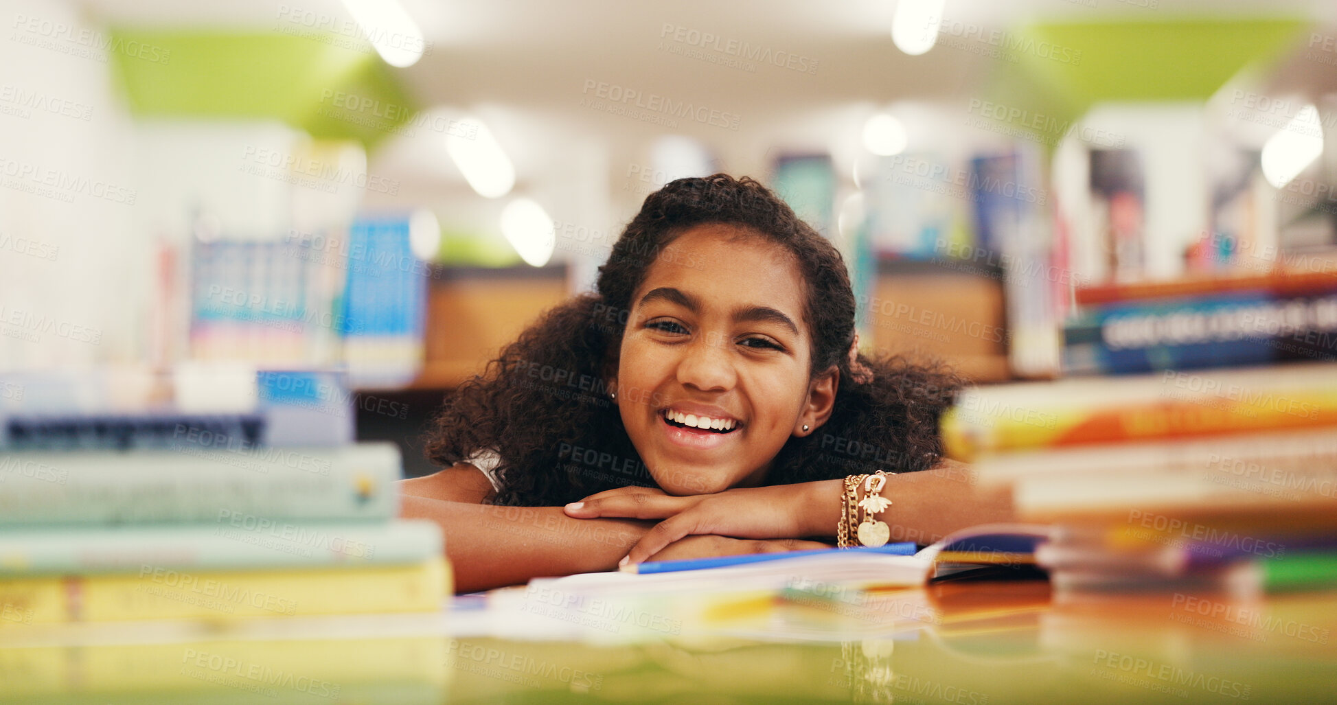 Buy stock photo Portrait, homework and girl in library, smile and education with growth, happy kid and relax. Student, knowledge and child development with confidence, laughing and pride with assignment and literacy