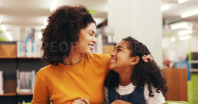 Buy stock photo Mom, girl and hug for learning at library with smile, support and care with guide for scholarship. People, mother and daughter with embrace, development or excited for education with school project