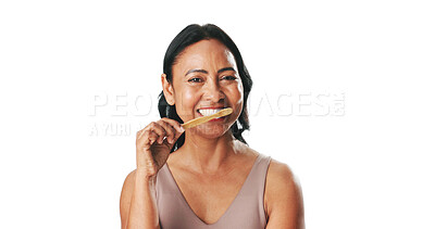 Buy stock photo Mature woman, brushing teeth and happy in studio portrait, hygiene and mockup space on white background. Person, bamboo toothbrush and smile with sustainability, product and oral wellness in Mexico