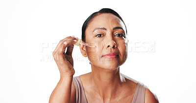 Buy stock photo Woman, skincare product and dropper in studio portrait, smile and mockup space on white background. Mature person, beauty serum and dermatology with essential oil, application or anti aging in Mexico