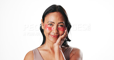 Buy stock photo Eye mask, portrait and woman in studio for dark circles, circulation and skincare. Mockup space, dermatology and mature person with beauty pads for wellness, hydration and health on white background