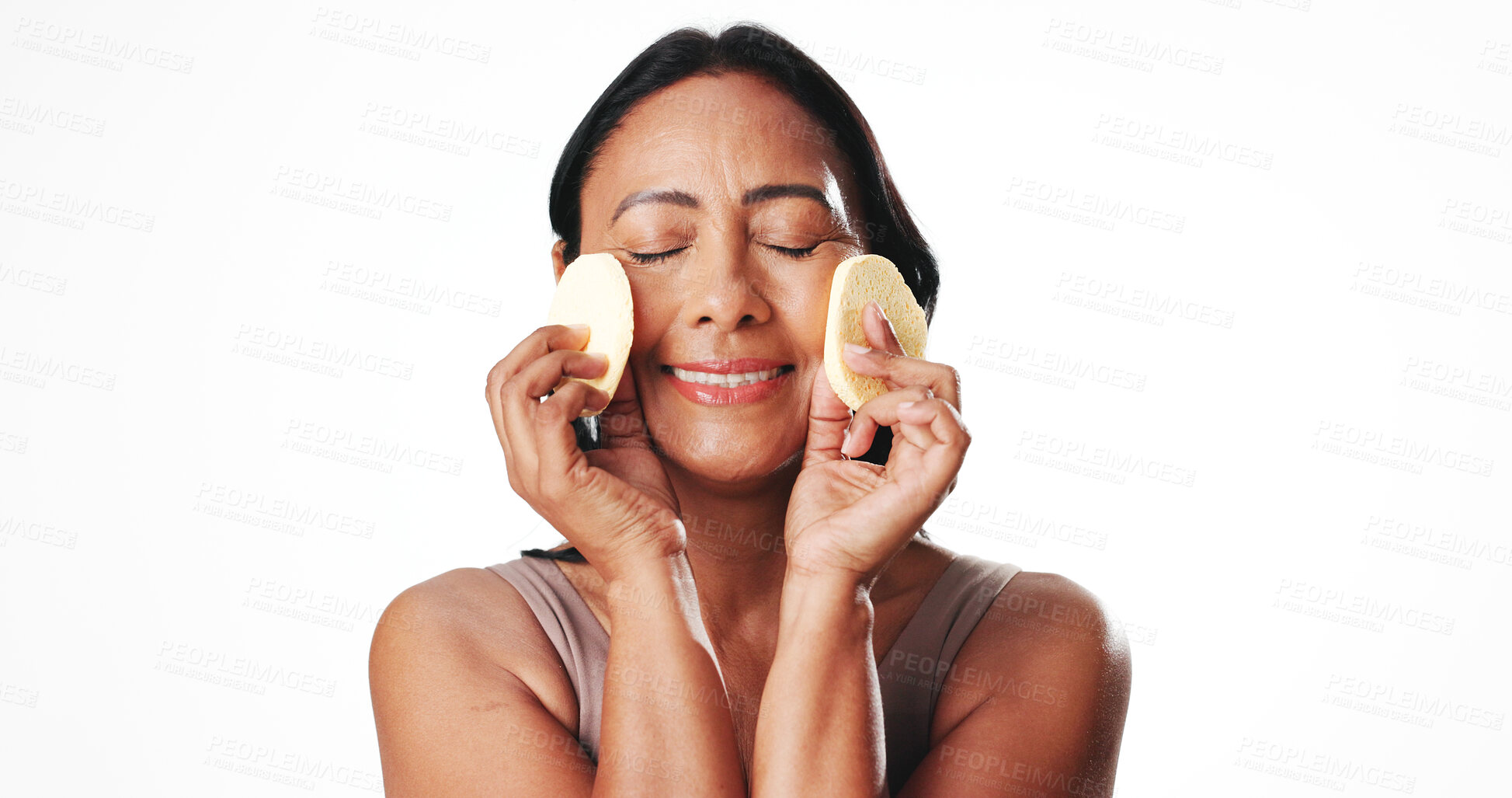 Buy stock photo Woman, sponge and skincare with smile in studio, beauty product and mockup space on white background. Mature person, pad and happy with dermatology, cosmetics and self care routine for anti aging