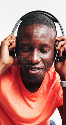 Buy stock photo Music, fitness and headphones with black man in studio for streaming service, workout playlist and health. Radio subscription, exercise podcast and smile with person on white background for audio