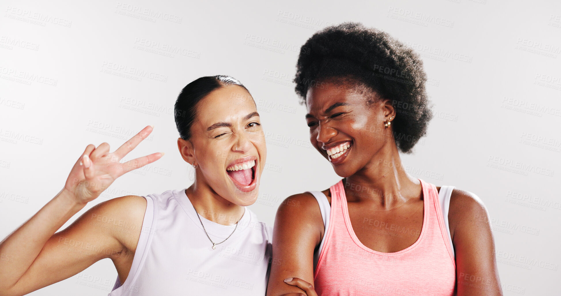 Buy stock photo Peace sign, fitness and portrait of women in studio with confidence for exercise, training and workout. Wink, athletes and happy friends with emoji for wellness, pride and health on white background
