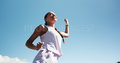 Buy stock photo Happy woman, fitness and winning with blue sky for race, sprint challenge or marathon in city. Low angle, female person or runner with smile for victory, achievement or accomplishment on mockup space