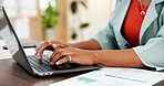 Laptop, business woman and hands typing in office, review data or investment metrics. Computer, keyboard and analyst in workplace with graphs, information or email for financial performance analysis