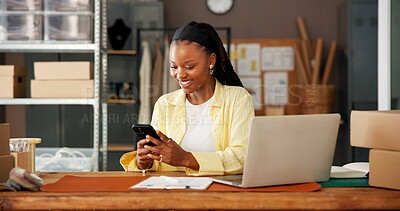 Buy stock photo Mobile, ecommerce and black woman in office for small business, fashion supply chain or online review. Logistics, phone and happy worker with delivery update, typing or reading email for distribution