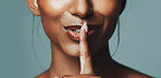 Beauty, hand gesture and hush with mouth of woman in studio for cosmetics or dermatology secrets. Aesthetic, finger on lips and skincare with model isolated on gray background for gossip or privacy