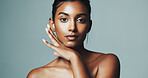 Portrait, skincare and woman with beauty in studio, natural glow or dermatology. Facial, shine and confident Indian model with cosmetics for aesthetic, skin health or self care on gray background