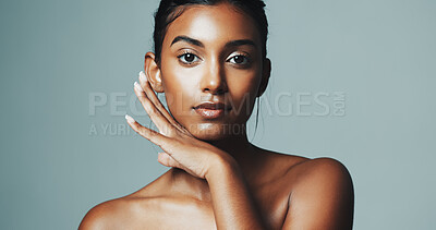 Buy stock photo Portrait, skincare and woman with beauty in studio, natural glow or dermatology. Facial, shine and confident Indian model with cosmetics for aesthetic, skin health or self care on gray background