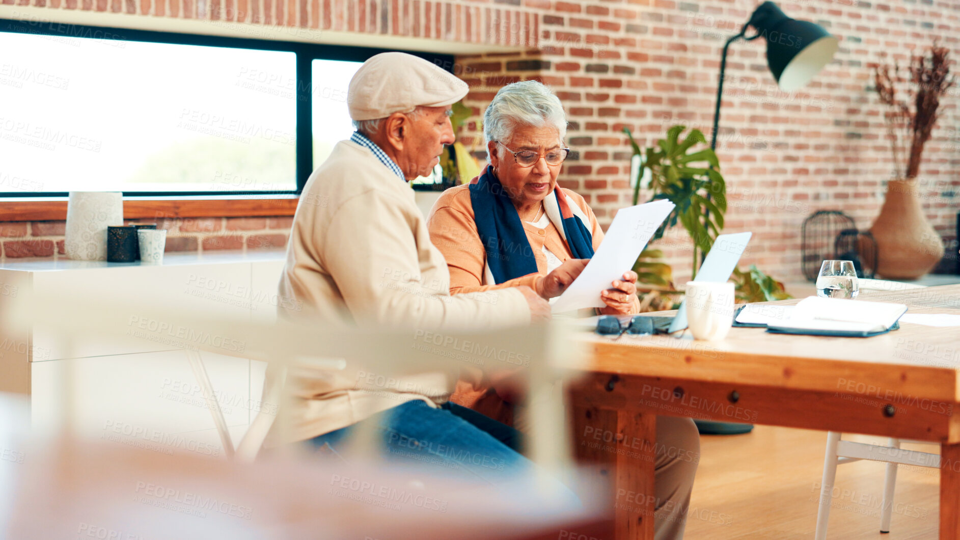 Buy stock photo Old couple, planning and finance paperwork in home with discussion, review and laptop for investment. Elderly man, woman and documents with report, asset management or talk with retirement income