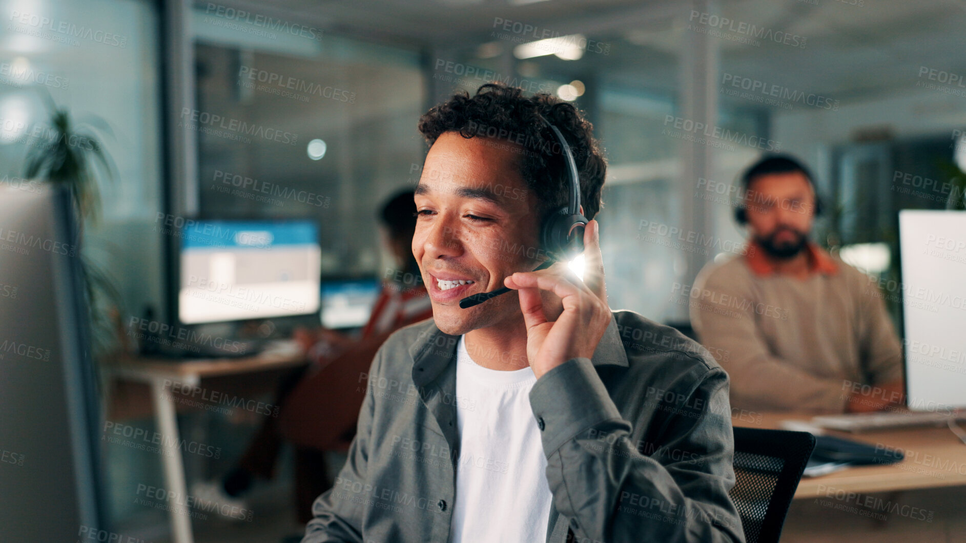 Buy stock photo Man, mic and call center with conversation at night, communication or contact us for online query. Help desk, support and telecom at computer, agent and headset with consulting at coworking office