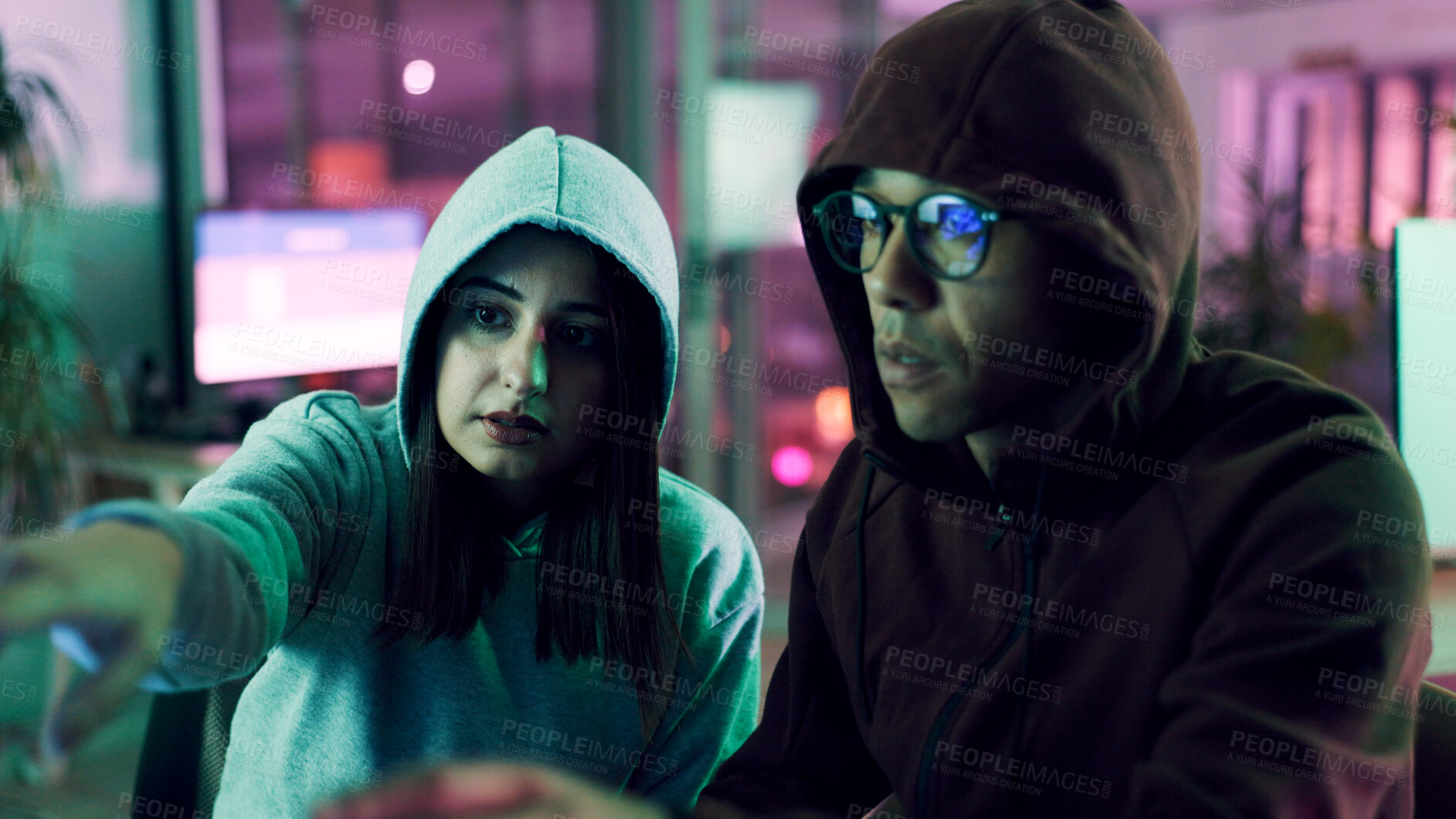 Buy stock photo Cyber crime, data theft and pointing with hacker people in neon office at night for phishing scam. Conversation, fraud or ransomware with man and woman in workplace to bypass firewall encryption