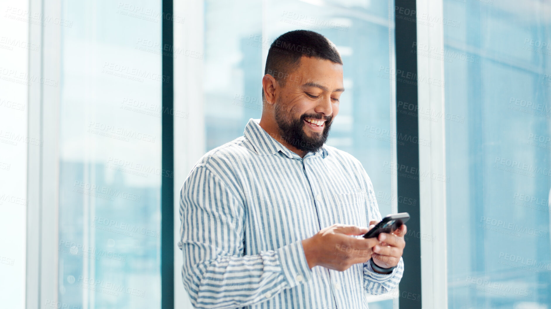 Buy stock photo Phone, smile and typing with business man in glass office for financial feedback or update. App, finance and text message with happy employee in corporate workplace for accounting or risk management