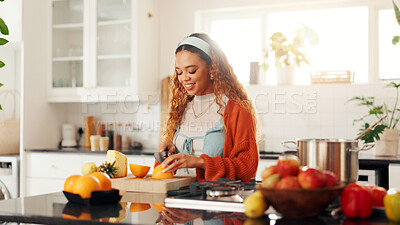 Buy stock photo Chop, fruit and wellness with woman in kitchen of home for diet or healthy food preparation. Knife, slice and wooden board with happy person at counter in apartment for culinary or organic detox