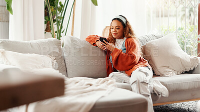 Buy stock photo Relax, girl and scroll with phone on sofa for internet browsing, social media post or weekend break. Smile, woman and smartphone in home for streaming subscription, dating app profile or text message