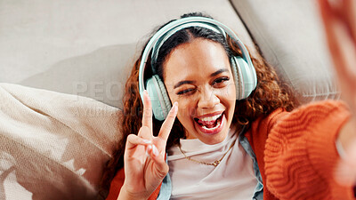 Buy stock photo Woman, influencer and peace sign with headphones for streaming, photography or profile picture in home. POV, person or vlogger with smile, emoji and selfie for content creation in house living room