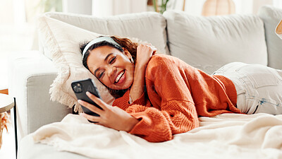 Buy stock photo Phone, relax and laugh with woman on sofa  in home for social media, streaming online video and post comment. Meme, communication app and digital chat platform with person in living room in house