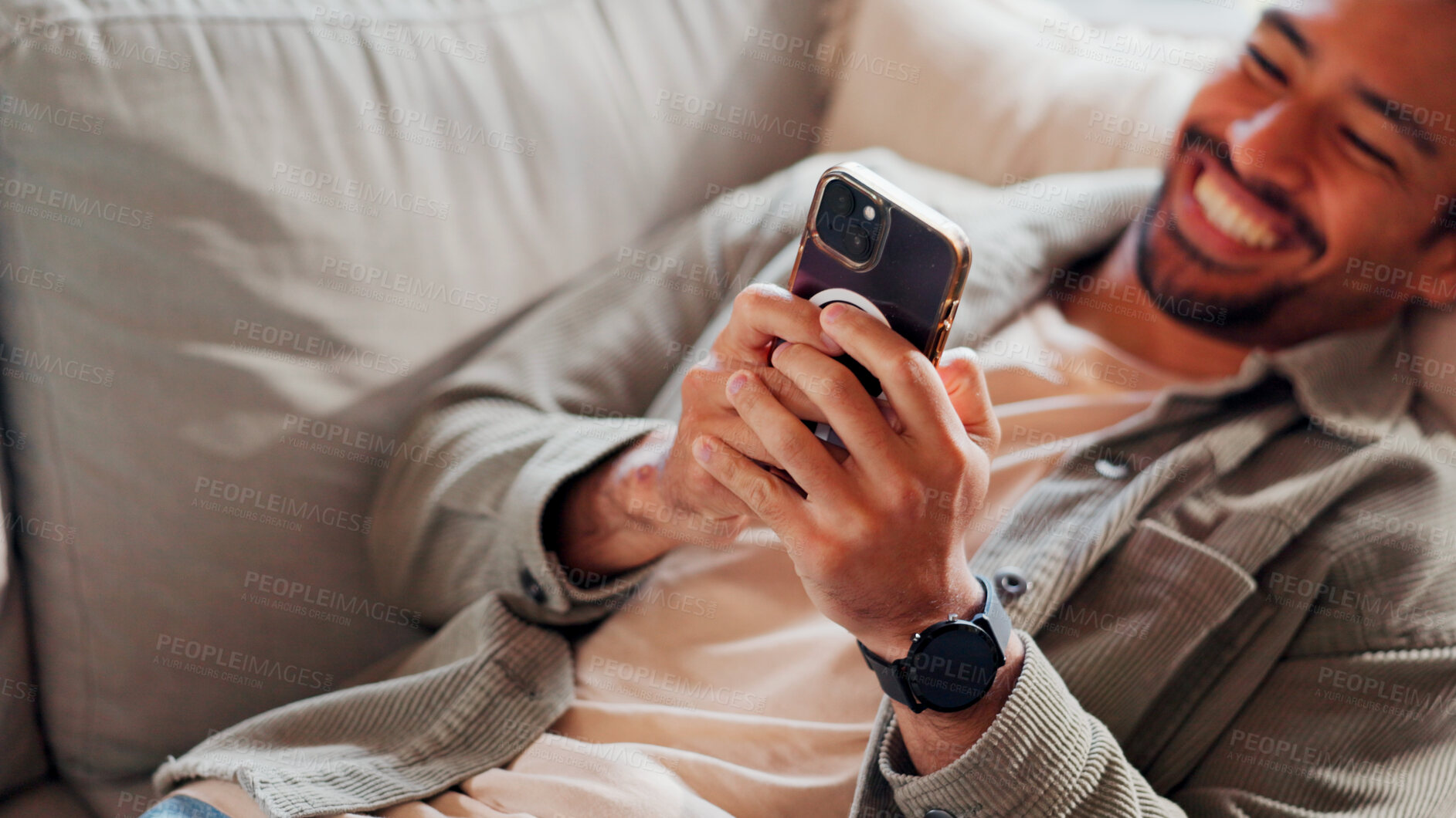 Buy stock photo Hands, smartphone and man relax in home for online dating, social media profile or post. Mobile, smile and person in living room for communication with contact, typing text or  internet with top view