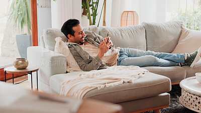 Buy stock photo Smile, cellphone and man relax on sofa for online dating, social media profile and post. Mobile, reading and happy person in home for communication with contact, typing text and response on internet