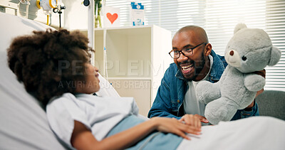 Buy stock photo Boy, father and happy for teddy in hospital bed, present and care with support for recovery. Black family, child and smile with bear, visit or gift with motivation for healing with illness at clinic
