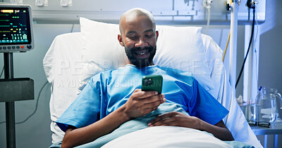 Buy stock photo Medical, relax and black man in hospital with phone, video streaming or message update on surgery. Healthcare, rest and patient in clinic with tech, digital scroll or online communication in recovery