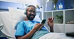 Music, phone and smile of black man in hospital bed for medical recovery, streaming or treatment. App, audio and headphones with happy patient lying in healthcare clinic for rehabilitation or rest