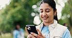 Phone, typing and volunteer with woman in park for charity, community outreach or food drive. App, smile and text message with happy person outdoor for activism, donation or ngo communication