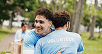 Happy man, hug or volunteer with embrace for community service or commitment together in park. Male person, team or NGO with smile, trust or support for global outreach, charity or donation in nature