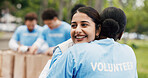 Volunteer, women outdoor or hug with smile for NGO support, sustainability project or nonprofit service. Happy, people or team with embrace in park for charity work, eco friendly outreach or kindness