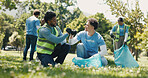 Fist bump, volunteering and men in park, cleaning and NGO charity with collaboration. Outdoor, friends and people with trash bag, gesture or motivation with eco friendly campaign or community support