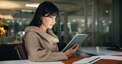 Buy stock photo Tablet, night and business woman in office, reading report or fact check for article. Company, journalist and mature editor with technology for news story, research or schedule with bokeh on overtime