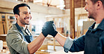 Happy man, carpenter or handshake with agreement for partnership, b2b or deal in workshop. Male people, employees or woodworker shaking hands with wood, timber or lumber for DIY or furniture business