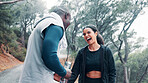 Interracial couple, fitness and laughing together in nature for adventure trail, exercise and wellness. Forest, man and woman for health, cardio workout and funny joke with morning walk and bonding