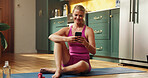 Exercise, phone and pilates with woman on floor in kitchen of home for social media update. App, fitness and typing with happy person in apartment for communication, holistic health or wellness
