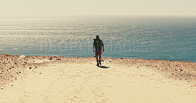 Buy stock photo Back, hiking and horizon at ocean with man on sand outdoor for adventure, fitness or hobby. Coast, exercise and sea space with hiker walking in nature for physical activity, trekking or wellness