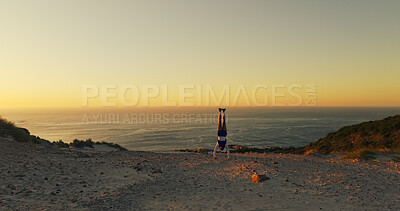 Buy stock photo Aerial view, handstand and horizon with man outdoor at ocean for exercise, fitness or hiking hobby. Balance, upside down and space with person in nature for training or workout routine at sunset