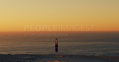 Buy stock photo Horizon, handstand and space with man outdoor at ocean for exercise, fitness or hiking hobby. Balance, upside down and environment with person in nature for training or workout routine at sunset