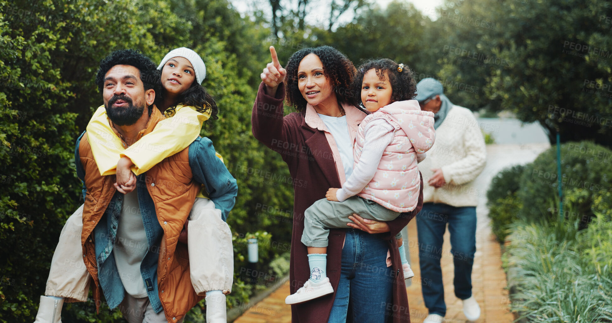 Buy stock photo Family, children and walk at park, happy and piggy back with point for sightseeing, holiday and bonding. People, parents and grandparents with kids, vacation or outdoor together at urban garden