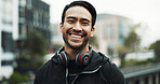 Fitness portrait, man and happy in city for exercise break, wellness progress and cardio training. Headphones, athlete and smile in urban town for workout rest, running practice and pace improvement