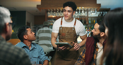 Buy stock photo Waiter man, tablet and friends order at bar, talk and option for drinks, choice and wine list. People, group and server with tech, digital menu or app for customer experience with decision at pub