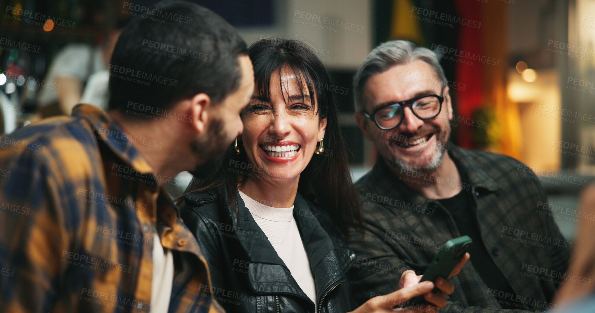 Buy stock photo Happy, friends and people in restaurant with phone laughing at online joke, conversation and talking. Bar, night and men with woman on smartphone for bonding, connection and social reunion on weekend