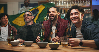 Buy stock photo Friends, excited and watching tv with drinks at sports bar, football competition or match with Brazil flag. Happy people, group and bonding with soccer game, live stream or broadcast with beer at pub