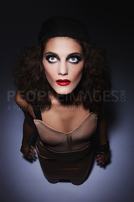 Buy stock photo Beauty, makeup and above of woman in studio for makeover, cosmetics and glamour with spotlight. Cosmetology, confidence and person with red lipstick, eyeshadow and salon aesthetic on dark background