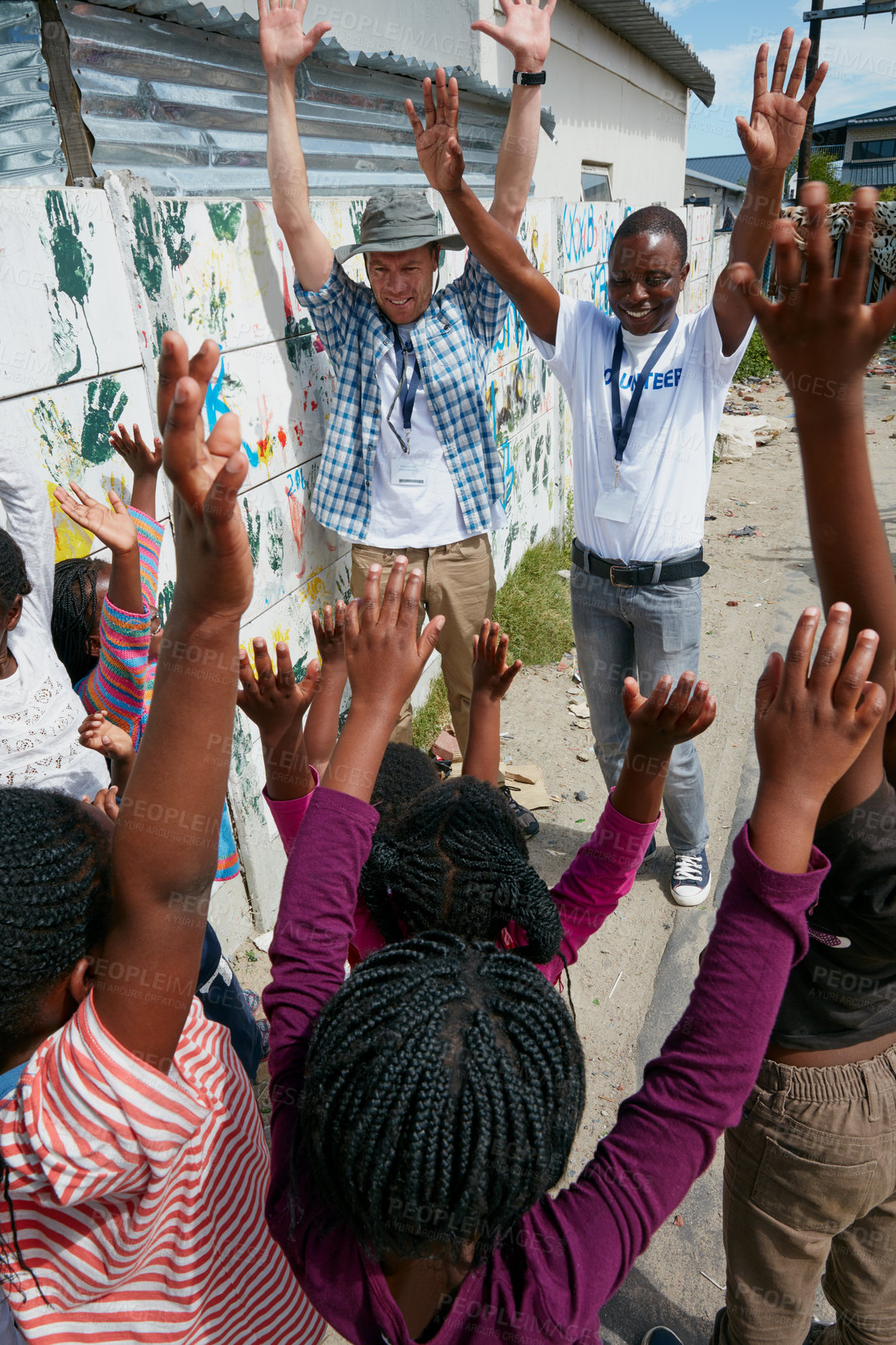 Buy stock photo Volunteer, success and hands raised with man and kids outdoor for community service, ngo program and charity. Kindness, social responsibility and welfare with children for humanitarian missionary