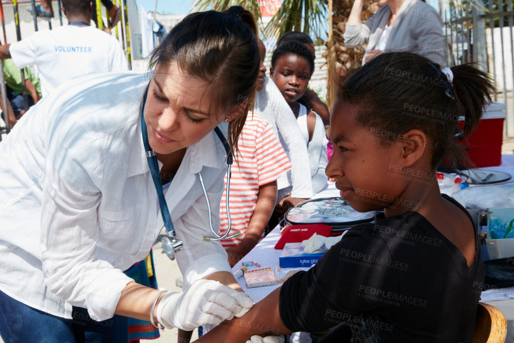 Buy stock photo Doctor, ngo and stethoscope with child outdoor for healthcare outreach, community service and volunteer. Medical aid program, welfare missionary and non profit organization with kids for charity