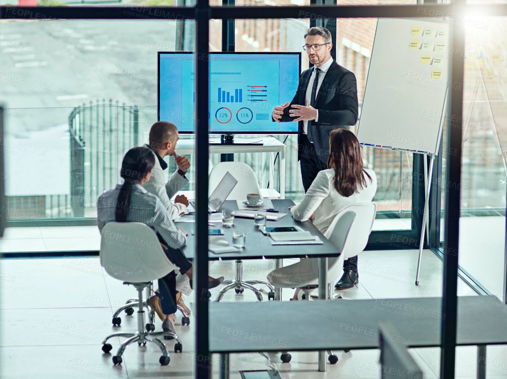 Buy stock photo Presentation, training and meeting with business man in office for investment data, broker review and speaker. Team, stock performance chart and infographic screen with employees for profit results