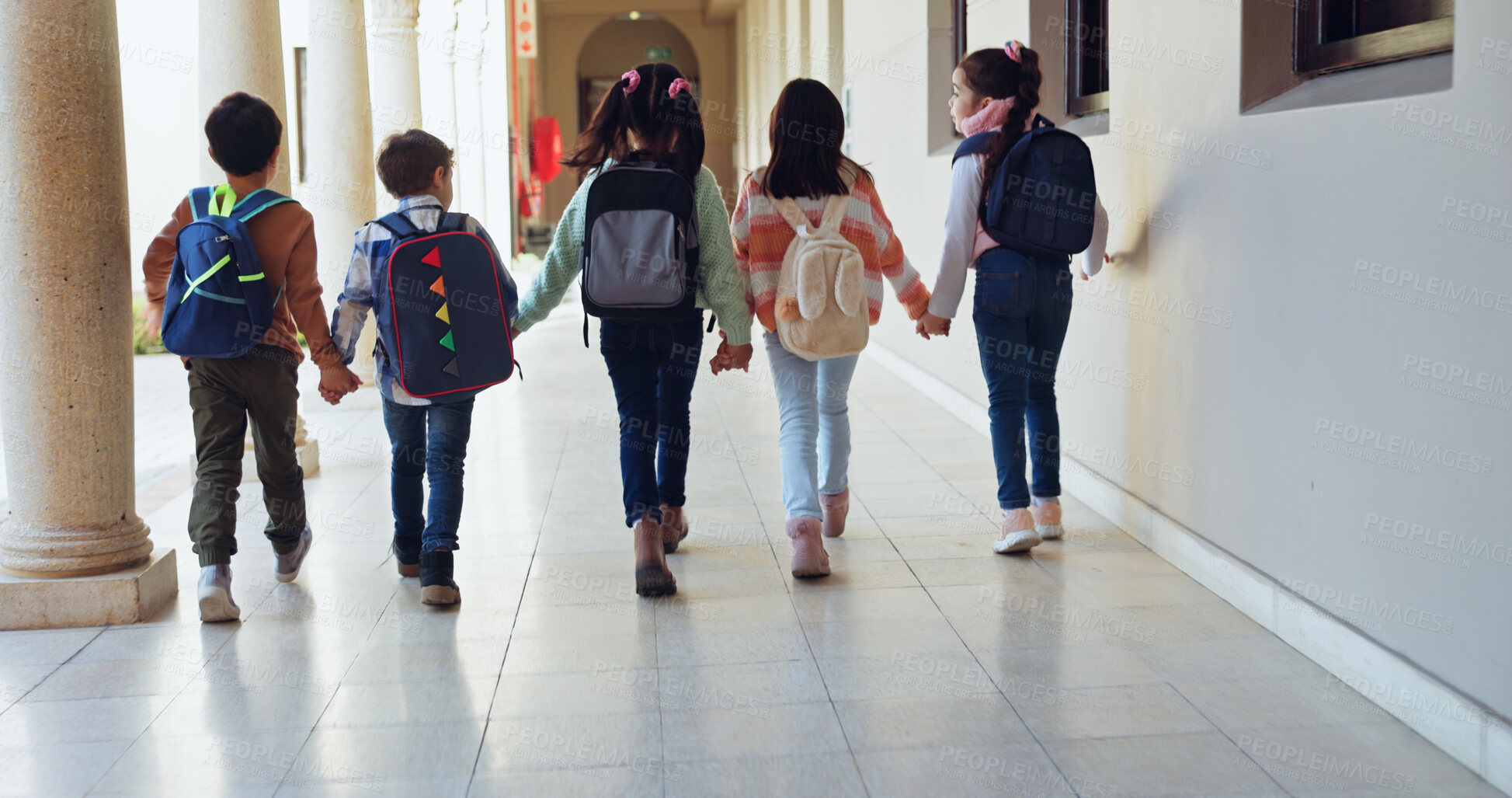 Buy stock photo Children, holding hands and group with back at school with care, connection and support in hallway. Kids, friends and together with bonding, education and development with scholarship at academy
