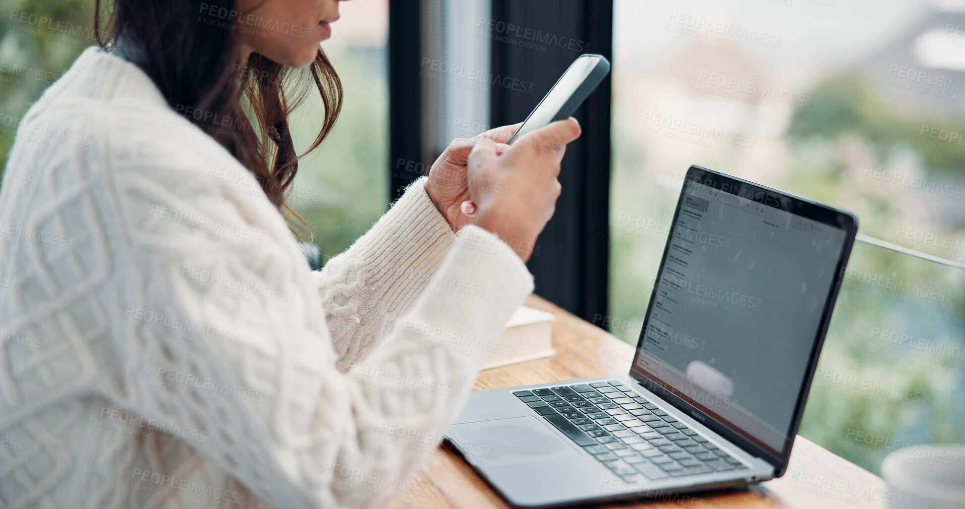 Buy stock photo Hands, phone and remote work with woman in home for planning, research or text message at window. App, contact and laptop with freelance employee at desk in apartment for communication or typing