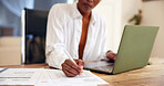 Person, hands and writing with laptop, documents or finance in home for budget planning or expenses. Freelancer, remote work or audit with computer, paperwork or bills for financial report in house